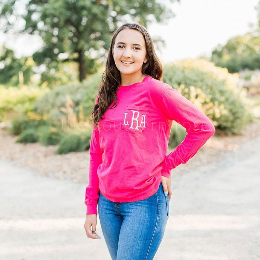 three letter monogram on a pink shirt
