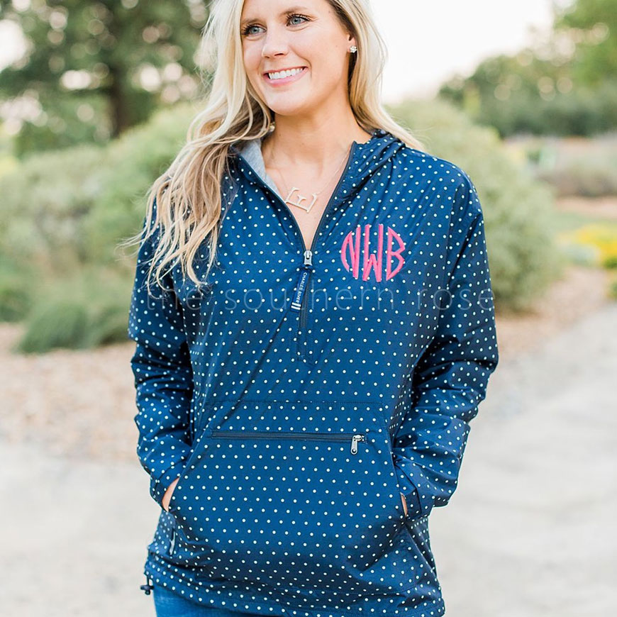 woman wearing a navy and pink monogrammed rain jacket