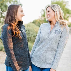 Two women wearing Military Monogram pullover jackets